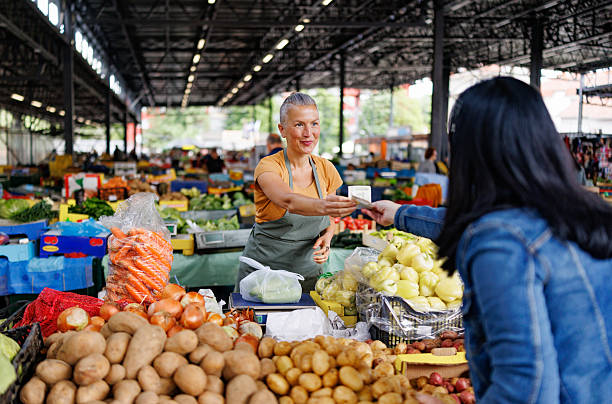 istock Friendly Interaction Between Vegetable Vendor and Buyer 2216724408