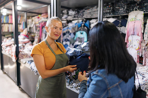 istock Lingerie Store Employee Helping Customer Choose 2216724804