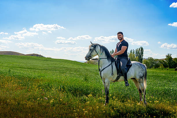 istock Young Man Stroking, Kissing and Hugging a Horse 2216728447