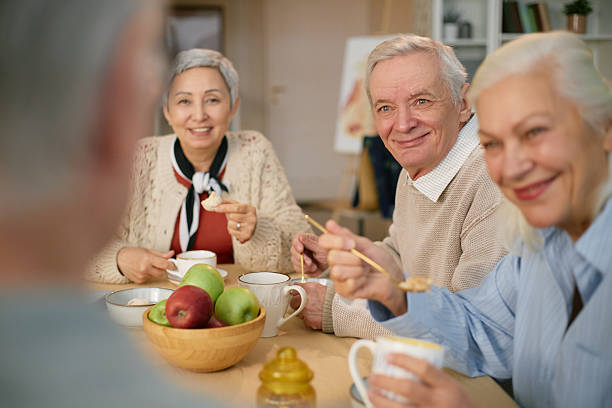 istock Senior Friends Enjoying Breakfast Together in Cozy Setting 2216733133