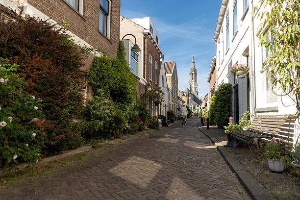 Handsome senior man biking through Delft whilst on a coastal vacation