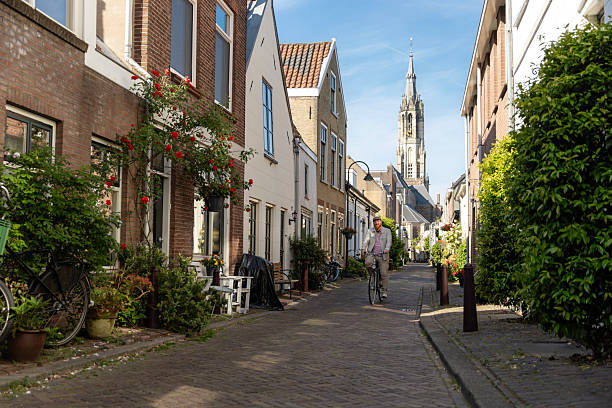 istock Handsome senior man biking through Delft whilst on a coastal vacation 2216737609