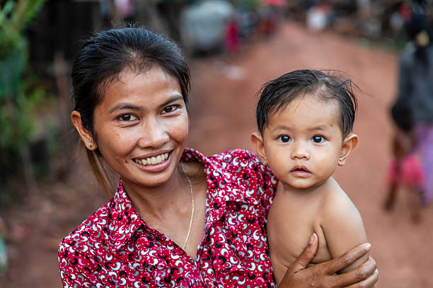 Portrait of mother holding her baby boy near Tonle Sap, Cambodia