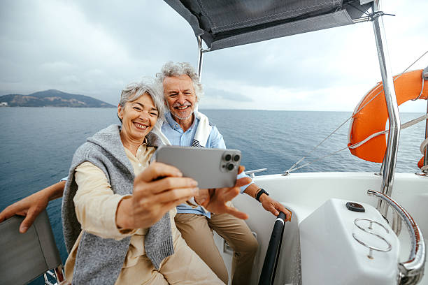 istock Senior couple taking selfie while sailing a catamaran together 2216739421