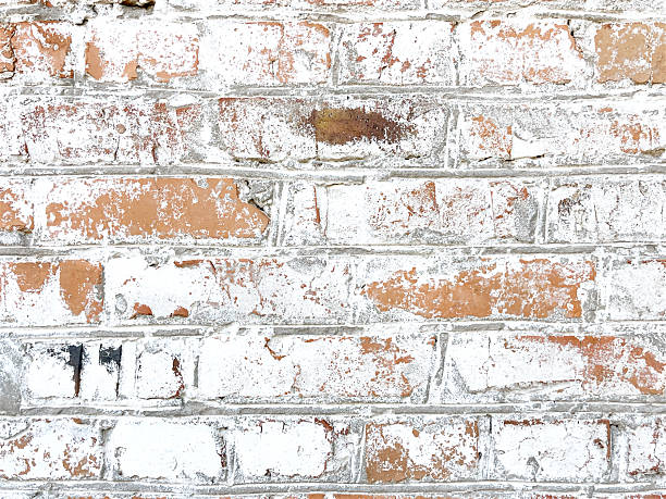 istock Close-up of an old brick wall with peeling white paint 2216743388