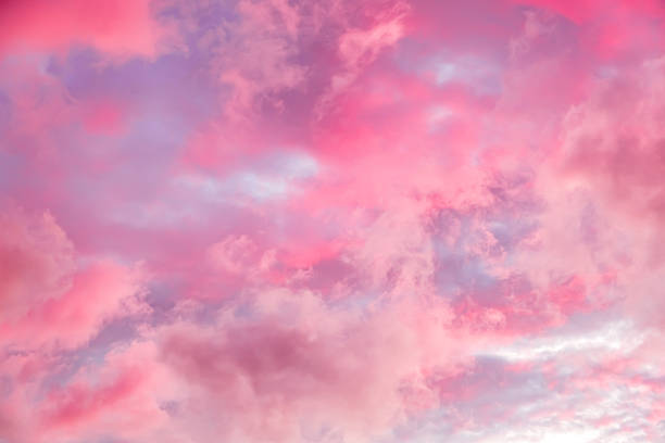 Fairytale sky with sugar cotton pink clouds in a dreamy background. Fantasy environment. Amazing heaven. Nature wallpaper. Idyllic backdrop. Romantic atmosphere. Textured abstract. High quality photo.