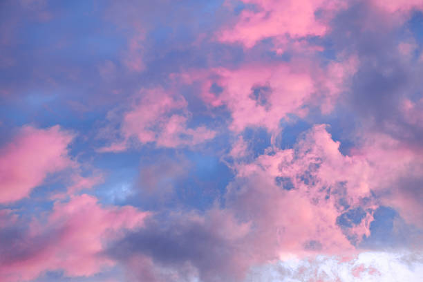 istock Fairytale sky with sugar cotton pink clouds in a dreamy background. Fantasy environment. Amazing heaven. Nature wallpaper. Idyllic backdrop. Romantic atmosphere. Textured abstract. High quality photo 2216754305
