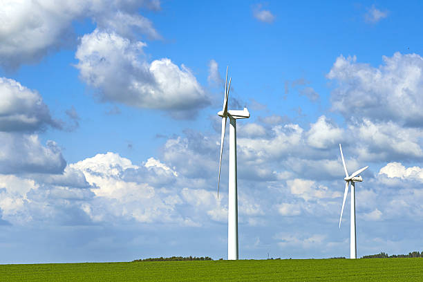 istock Wind turbines in a lush green landscape under a cloudy blue sky 2216763375