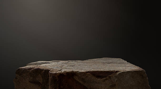 istock Stone, Rock beige brown podium isolated on dark cement wall studio light background well stage stand display products presentation, clipping paths 2216763620