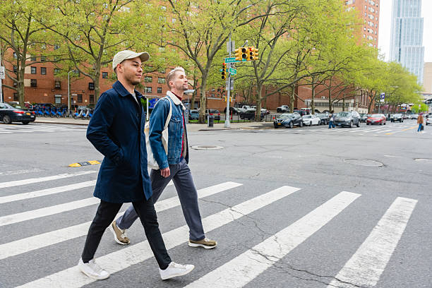 istock Two Men Walk Side by Side While Crossing a NYC Street 2216765674