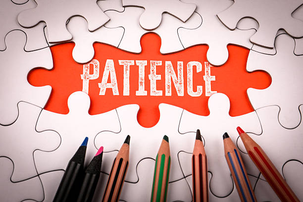 istock PATIENCE. White puzzle pieces and colored pencils 2216770604