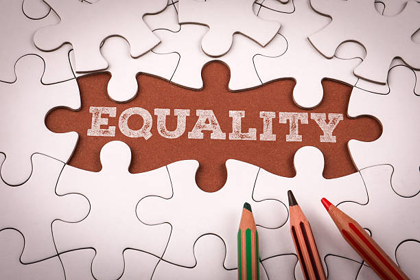 istock EQUALITY. White puzzle pieces and colored pencils 2216770613