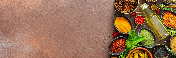 istock A visually striking arrangement of fresh spices and herbs on a brown surface, highlighting their vivid colors, intricate details, and rich culinary essence, banner 2216770687