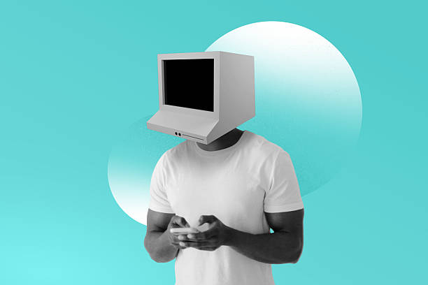 istock Man with retro computer monitor for head, using a smartphone, isolated on blue background. Artificial intelligence technology concept 2216771957