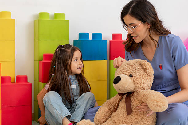 istock Pediatrician using teddy bear to comfort child in doctor's office 2216773569
