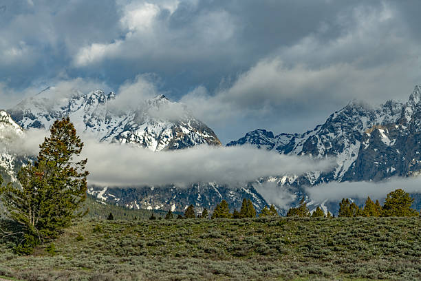 Low clouds and view of meadows and mountains where wildlife is abundant at Grand Teton National Park, Wyoming, United States.