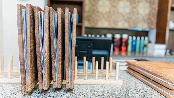 istock Stack of wooden menus on granite counter, restaurant background. 2216778073