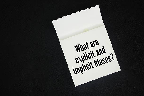 istock Paper book with the question words What are explicit and implicit biases? 2216780661