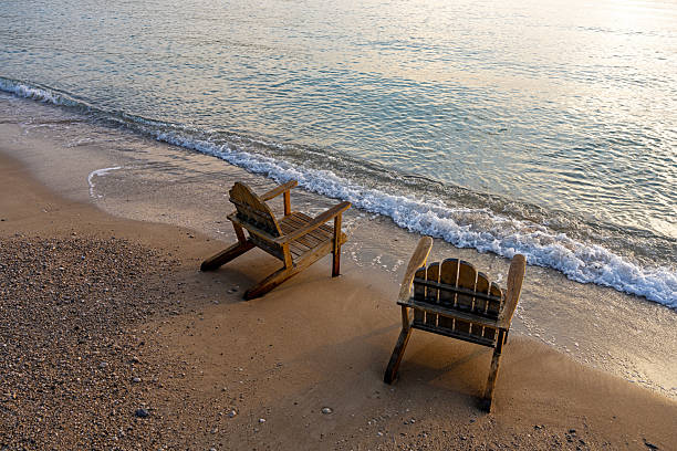 istock Silhouette of two deck chairs on a sandy beach at sunrise, Kemer Antalya 2216781685