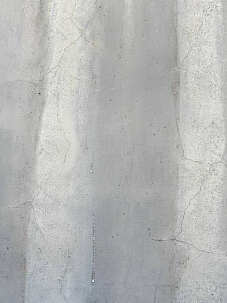 istock A grey wall with cracks and holes 2216782065