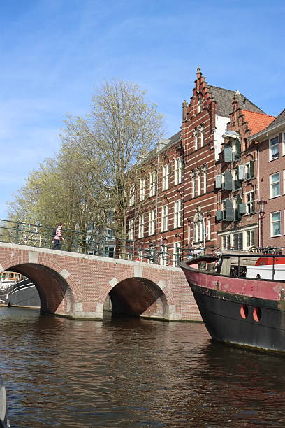 Amsterdam architecture, canal bridge and a house boat