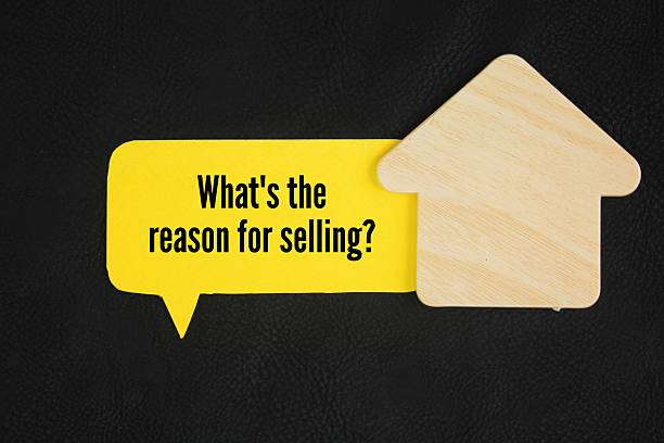 istock House shape and colored paper with the question words What's the reason for selling? 2216782549