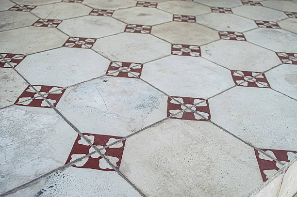 istock Distressed vintage floor tiles with a repeating octagonal and square pattern in red and white. Ideal for historical, architectural, and aged design themes 2216783012