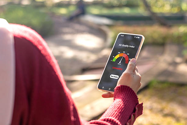 istock A woman checking the outdoor air quality index using an app on her smartphone. Selective focus. 2216785974