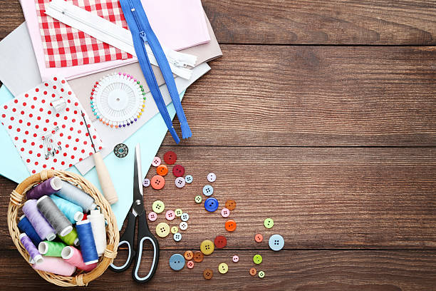 istock Sewing accessories on brown wooden table 2216787260