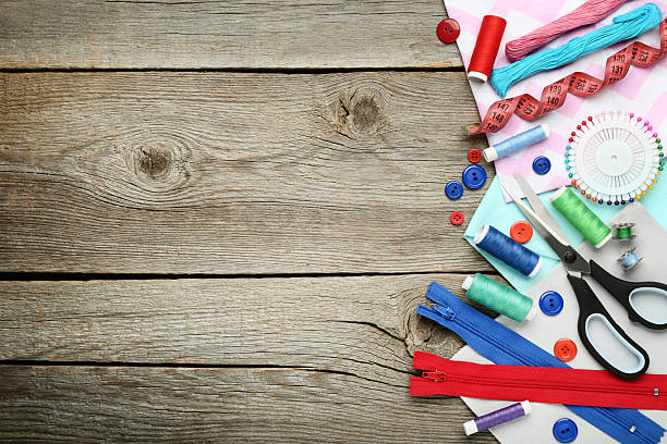 istock Sewing accessories on grey wooden table 2216787353