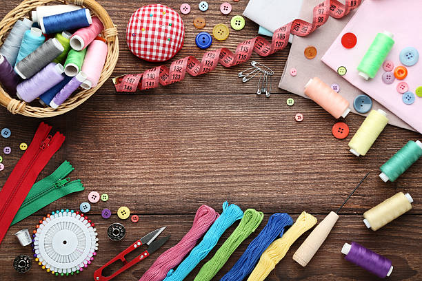 istock Sewing accessories on brown wooden table 2216788006