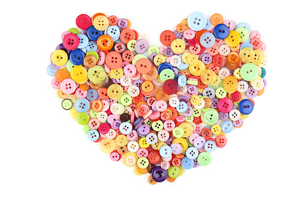 istock Colorful sewing buttons in heart shape on white background 2216788124
