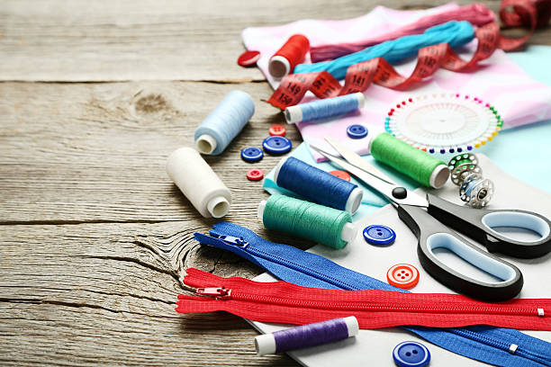 istock Sewing accessories on grey wooden table 2216788403