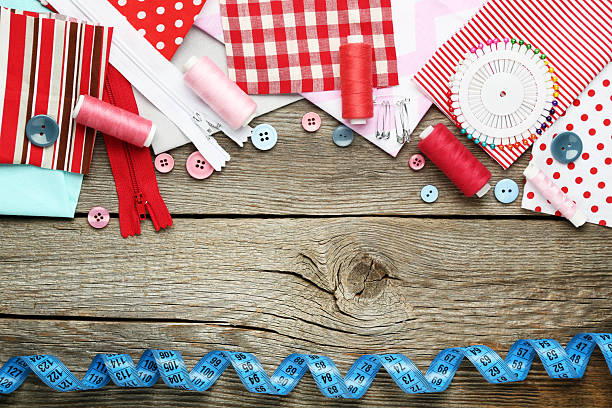 istock Sewing accessories on grey wooden table 2216788495