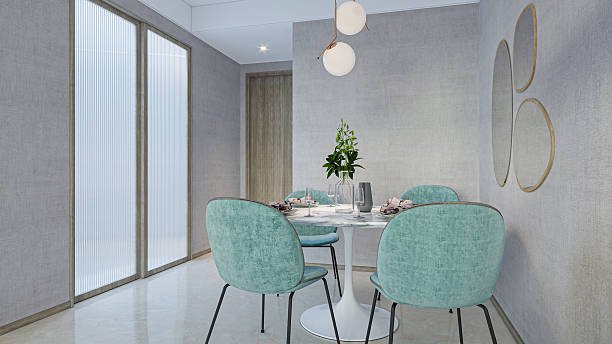 istock Modern Dining Nook: Stylish Teal Chairs and Round Table with Elegant Lighting 2216788579