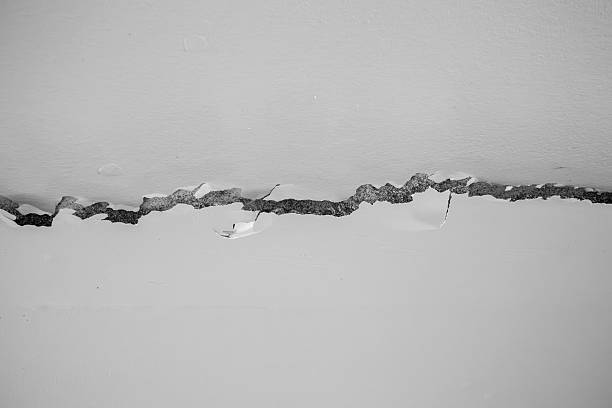 istock Horizontal Wall Crack on White Surface – Structural Damage and Home Repair Concept 2216789070