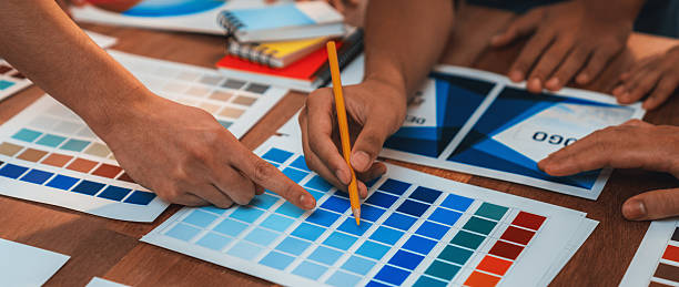 istock Graphic designer brainstorming logo and graphic arts at workshop. Scrutinize 2216789329