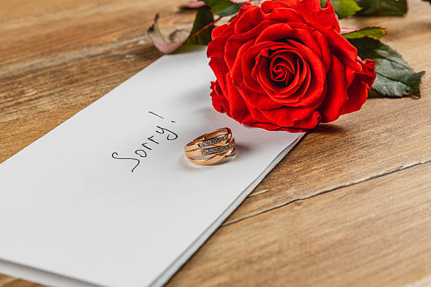 istock Engagement ring and rose convey heartache from broken engagement 2216792160