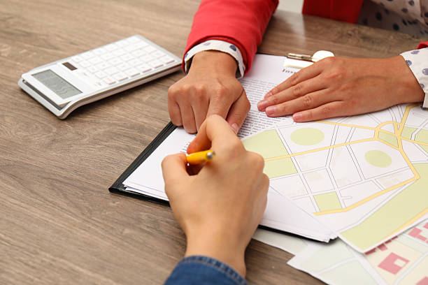 istock Real estate agent working with client at wooden table, closeup 2216798484