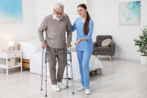 istock Nurse helping senior man with walking frame in clinic 2216799269