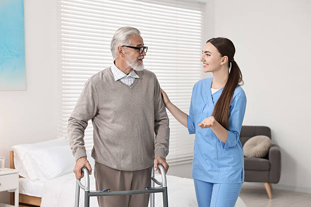 istock Nurse helping senior man with walking frame in clinic 2216799298