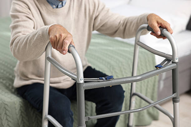 istock Senior man with walking frame on bed at home, closeup 2216799340