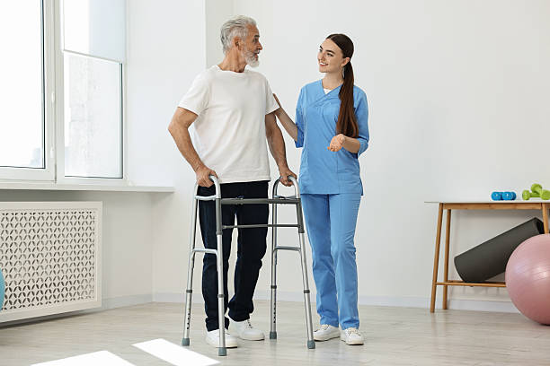 istock Nurse helping senior man with walking frame in clinic 2216799381