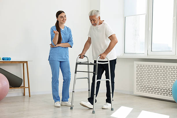 istock Nurse talking to senior man with walking frame in clinic 2216799383