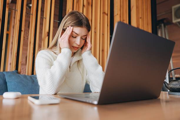 istock Stressed Freelancer Suffering Headache While Working on Laptop in Coffee Shop 2216799799