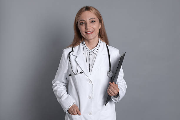 istock Doctor with stethoscope and clipboard on gray background 2216799842