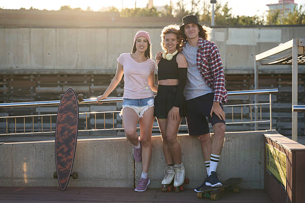 istock Young people posing with skateboards and roller skates at skatepark 2216800309