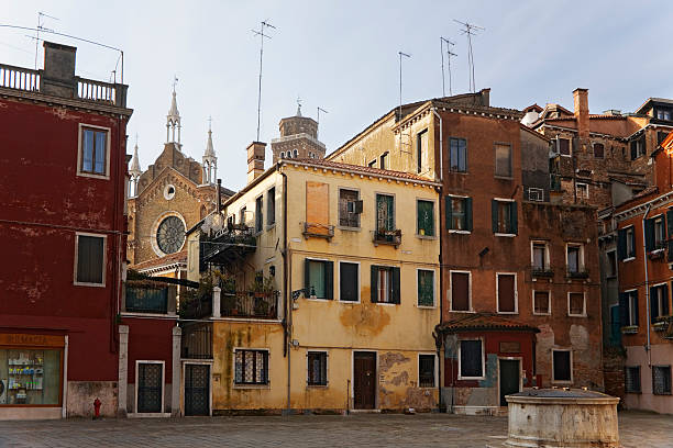 Campo San Stin, San Polo, Venice, Italy: a quiet square with picturesque houses, and the façade of the Frari visible beyond