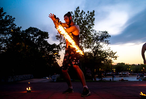 Low Angle View Of Man With Fire Crackers At Night