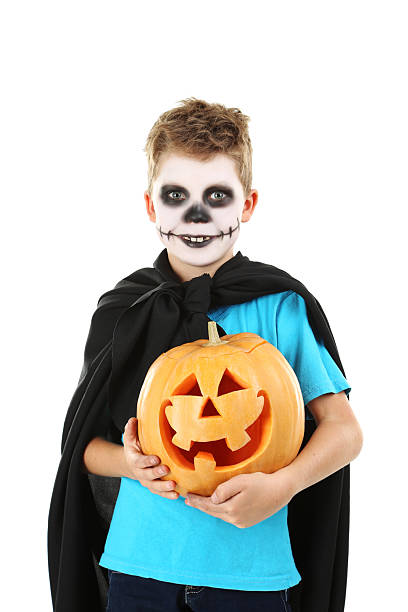 istock Little boy in halloween costume with pumpkin on white background 2216803841